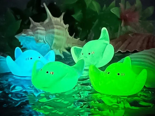 Glow-in-the-dark manta ray charms on a shoe shoe. These enchanting accessories light up in the dark, adding a marine-inspired touch to your footwear. Perfect for customizing your shoes with a unique and magical ocean theme.