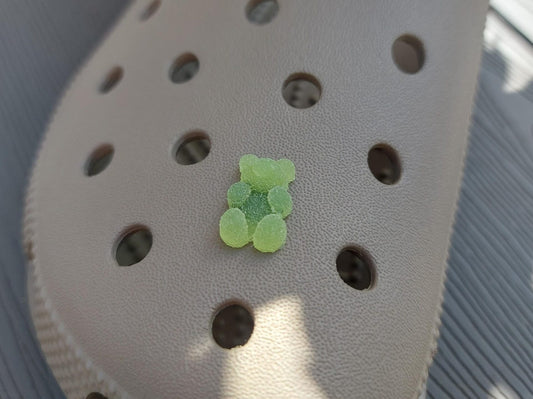 Close-up of sugar gummy bear charms on a shoe shoe, featuring bright, colorful gummy bear designs. The charms are securely attached, adding a playful, candy-inspired touch to the shoe with a fun and vibrant look.