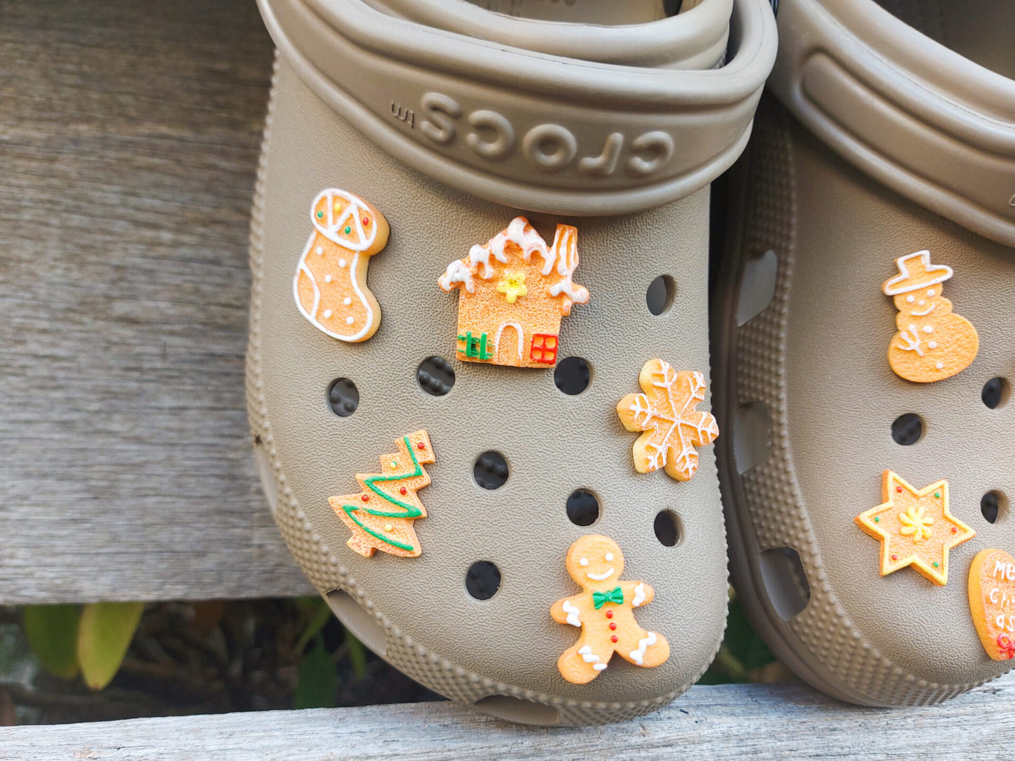 A collection of gingerbread-themed shoe charms shaped like Christmas trees, snowflakes, and stars, each with a realistic cookie appearance. These festive charms add a cozy, holiday-inspired touch to your footwear.