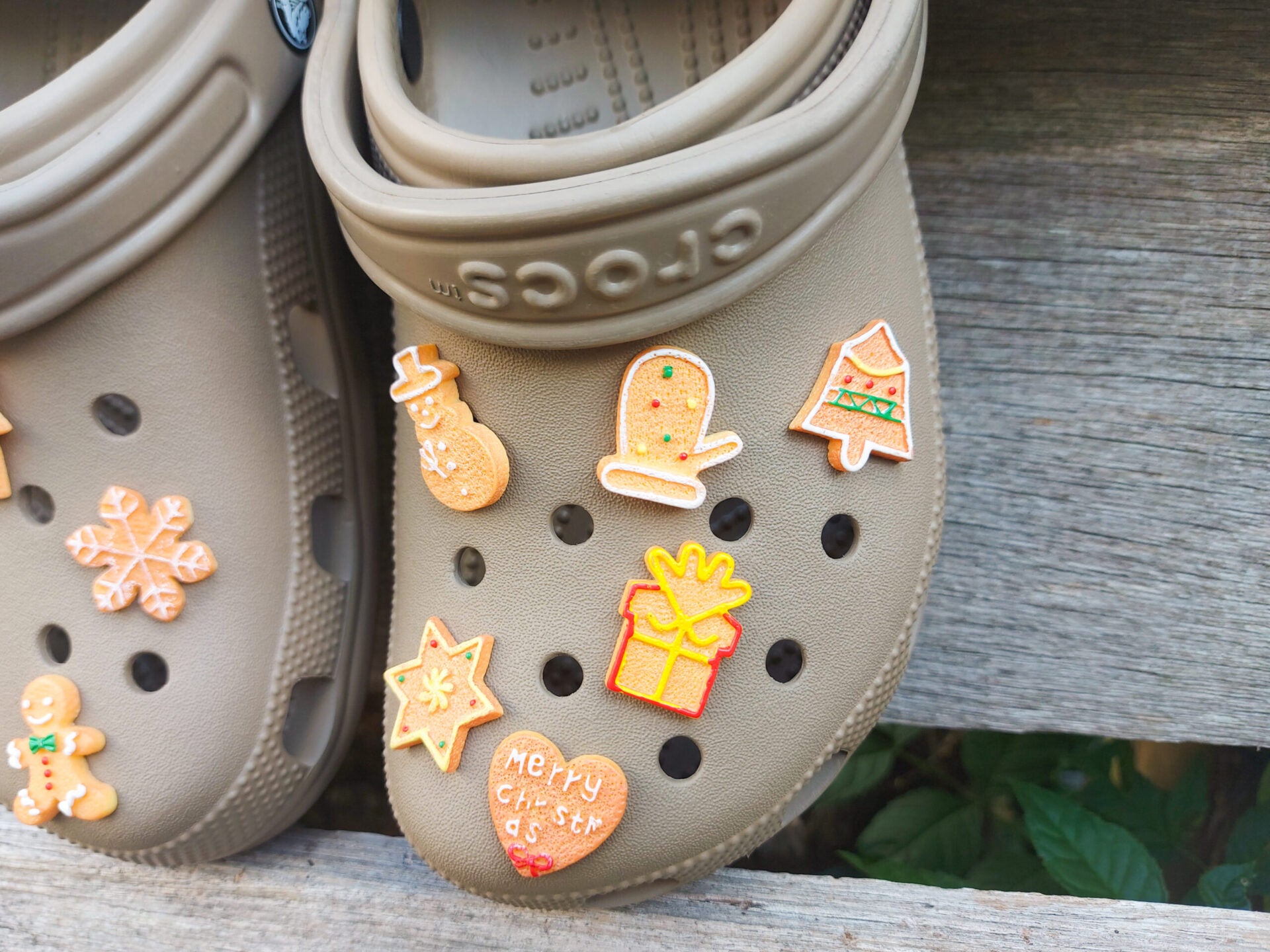 A collection of gingerbread-themed shoe charms shaped like Christmas trees, snowflakes, and stars, each with a realistic cookie appearance. These festive charms add a cozy, holiday-inspired touch to your footwear.