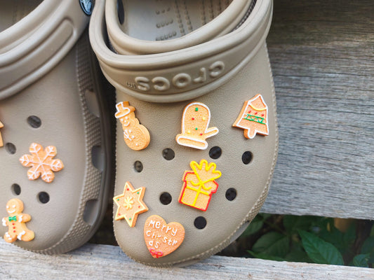A collection of gingerbread-themed shoe charms shaped like Christmas trees, snowflakes, and stars, each with a realistic cookie appearance. These festive charms add a cozy, holiday-inspired touch to your footwear.