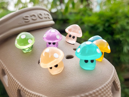 Glow-in-the-dark mushroom charms on a pair of shoes shoes. These luminous accessories add a magical, whimsical touch to your footwear, perfect for customizing with a unique forest-inspired design that glows beautifully in the dark.