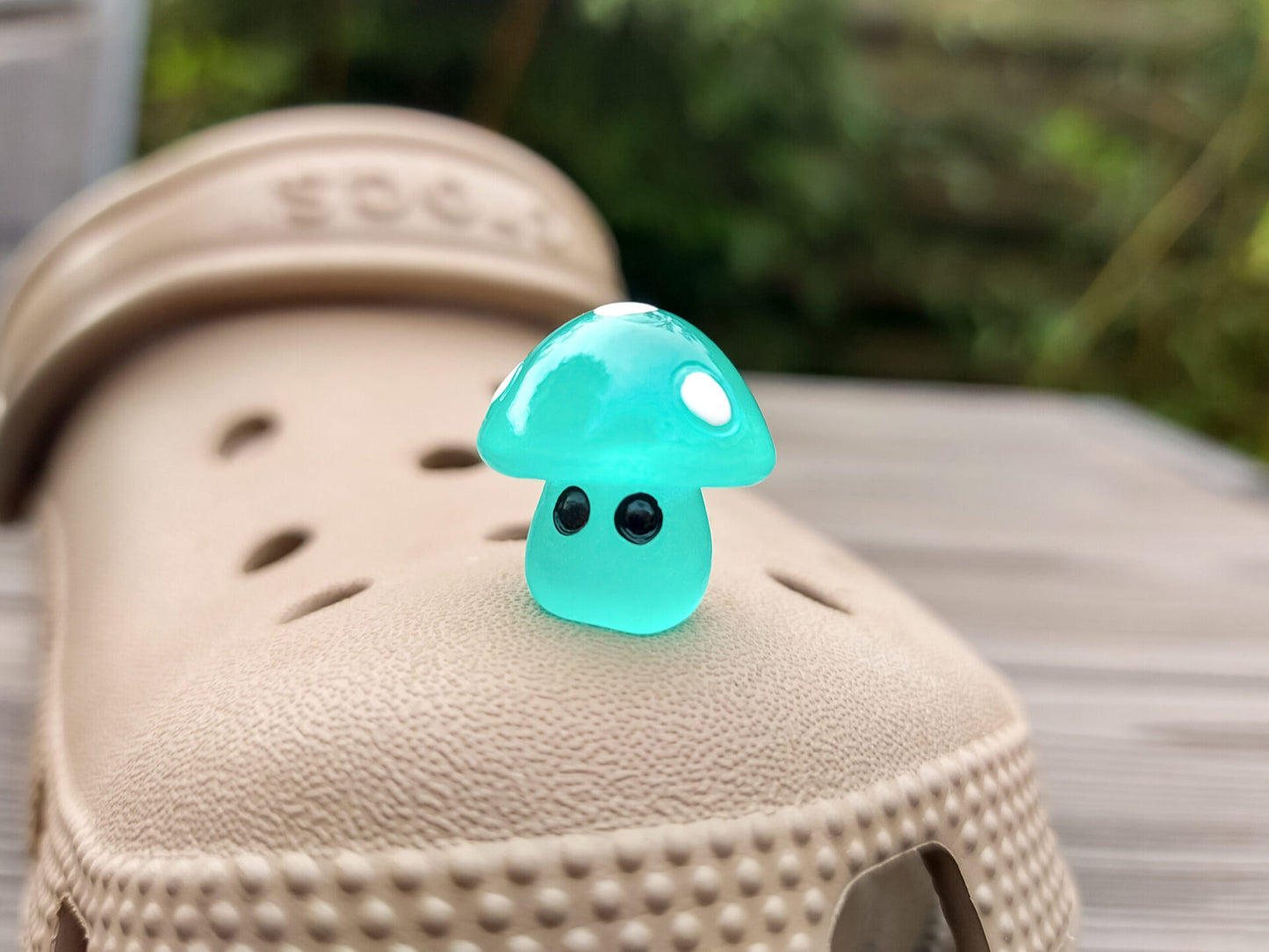 Glow-in-the-dark mushroom charms on a pair of shoes shoes. These luminous accessories add a magical, whimsical touch to your footwear, perfect for customizing with a unique forest-inspired design that glows beautifully in the dark.