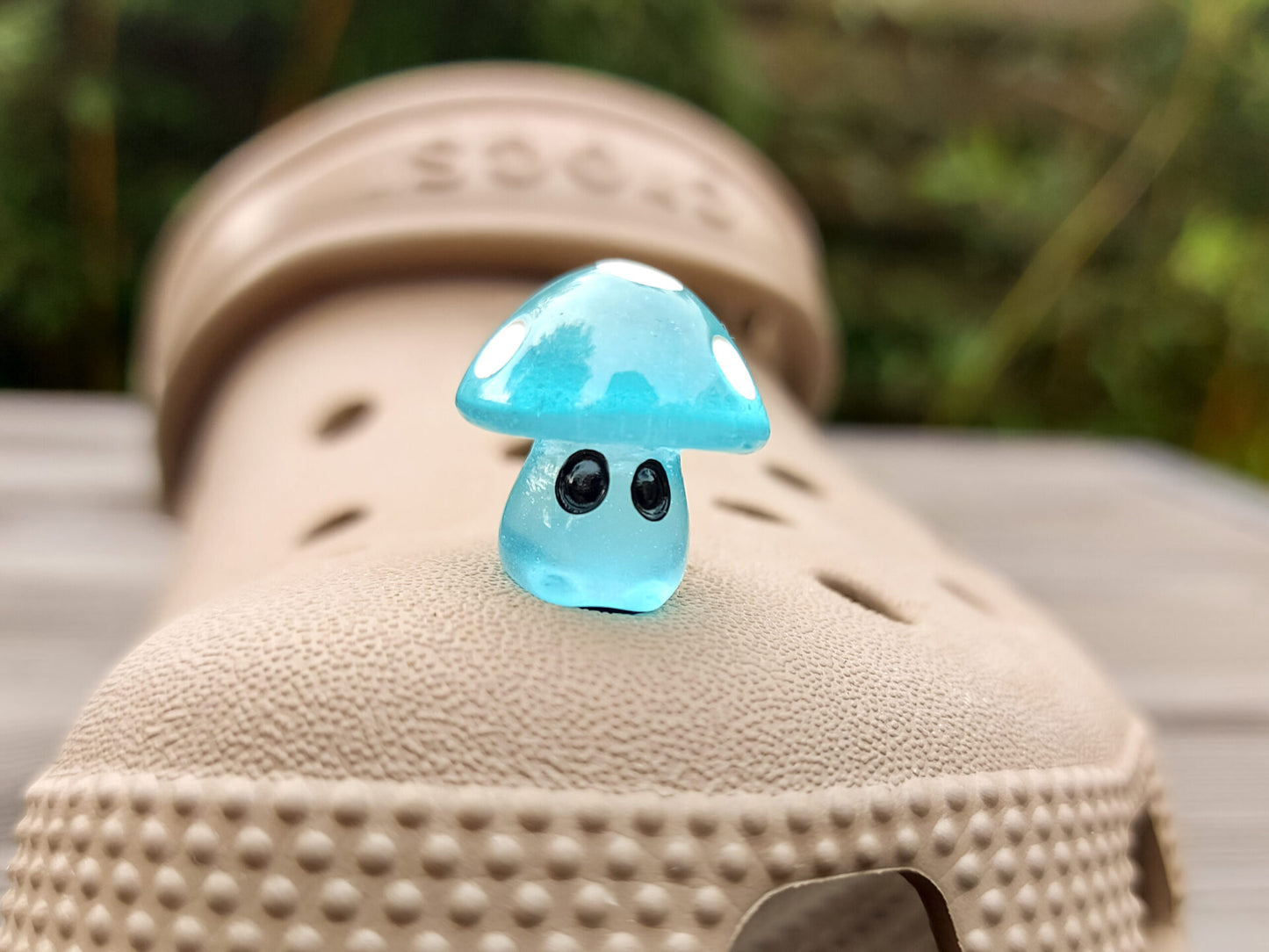 Glow-in-the-dark mushroom charms on a pair of shoes shoes. These luminous accessories add a magical, whimsical touch to your footwear, perfect for customizing with a unique forest-inspired design that glows beautifully in the dark.