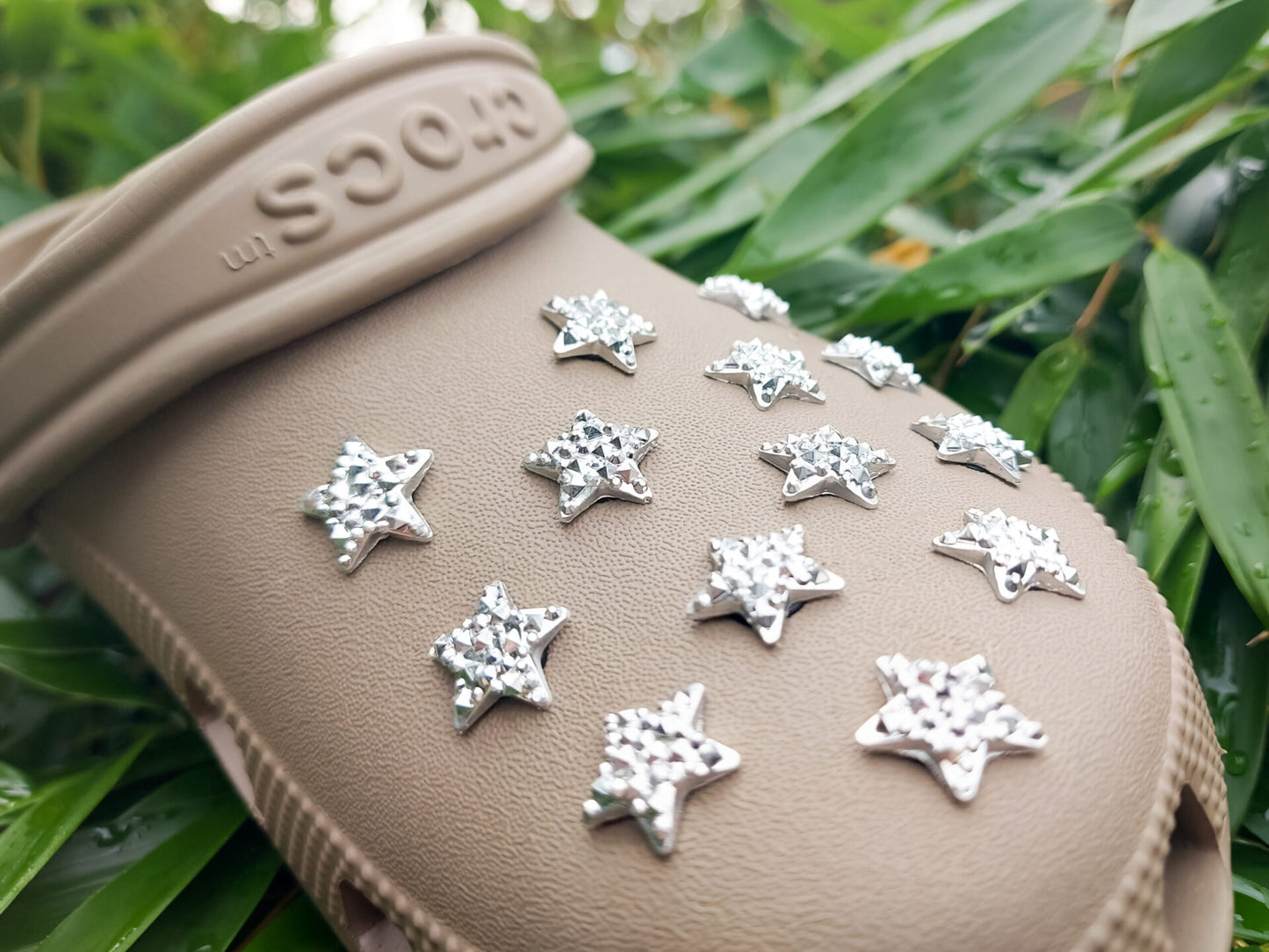 A set of crystal star-shaped charms for shoes, featuring sparkling, light-catching designs. The charms are arranged to showcase their dazzling look, with each star creating a celestial vibe perfect for adding a bit of shine and magic to any shoe.