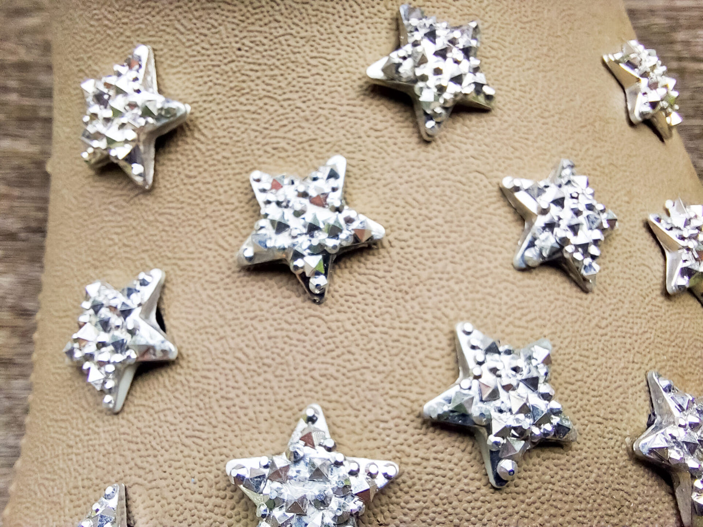 A set of crystal star-shaped charms for shoes, featuring sparkling, light-catching designs. The charms are arranged to showcase their dazzling look, with each star creating a celestial vibe perfect for adding a bit of shine and magic to any shoe.