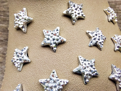 A set of crystal star-shaped charms for shoes, featuring sparkling, light-catching designs. The charms are arranged to showcase their dazzling look, with each star creating a celestial vibe perfect for adding a bit of shine and magic to any shoe.