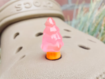 A beige shoes shoe adorned with small, glowing Christmas tree charms in a variety of soft colors, including yellow, pink, green, and blue. Each tree charm has a luminous effect, creating a festive and playful look.