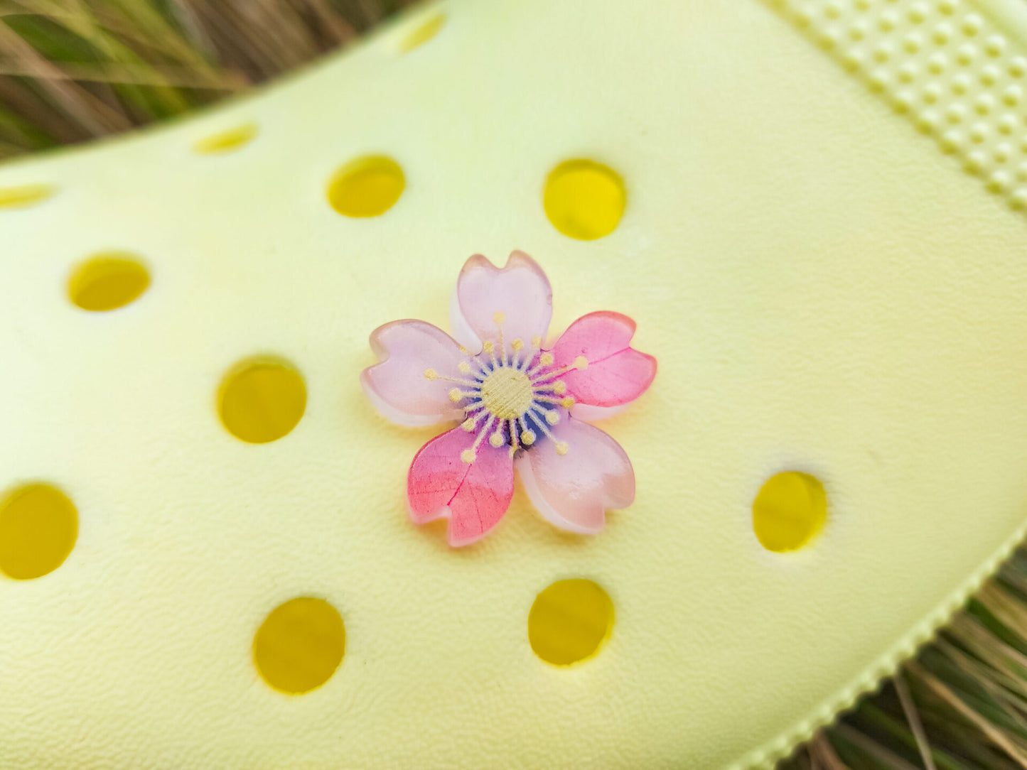 Glow-in-the-dark cherry blossom shoe charms in six colors—pink, dark pink, purple, blue, green, and orange—adding a soft, luminous effect to shoes with flower-themed elegance.