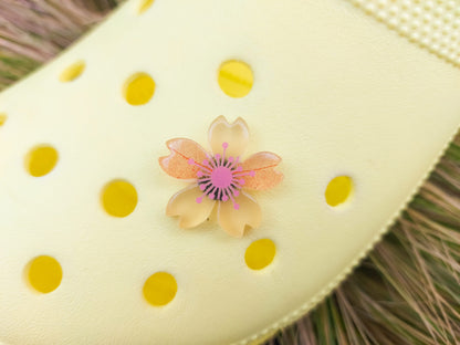 Glow-in-the-dark cherry blossom shoe charms in six colors—pink, dark pink, purple, blue, green, and orange—adding a soft, luminous effect to shoes with flower-themed elegance.