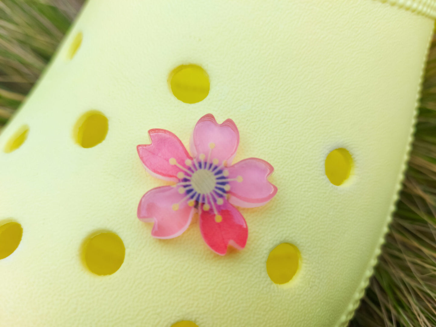 Glow-in-the-dark cherry blossom shoe charms in six colors—pink, dark pink, purple, blue, green, and orange—adding a soft, luminous effect to shoes with flower-themed elegance.