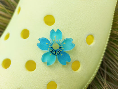 Glow-in-the-dark cherry blossom shoe charms in six colors—pink, dark pink, purple, blue, green, and orange—adding a soft, luminous effect to shoes with flower-themed elegance.