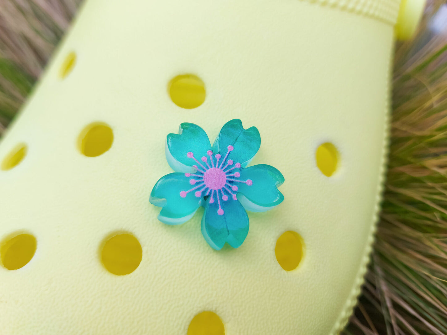 Glow-in-the-dark cherry blossom shoe charms in six colors—pink, dark pink, purple, blue, green, and orange—adding a soft, luminous effect to shoes with flower-themed elegance.