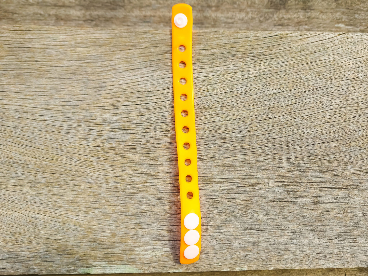 A flexible, adjustable bracelet with multiple charm slots, available in a range of vibrant colors for a personalized look.