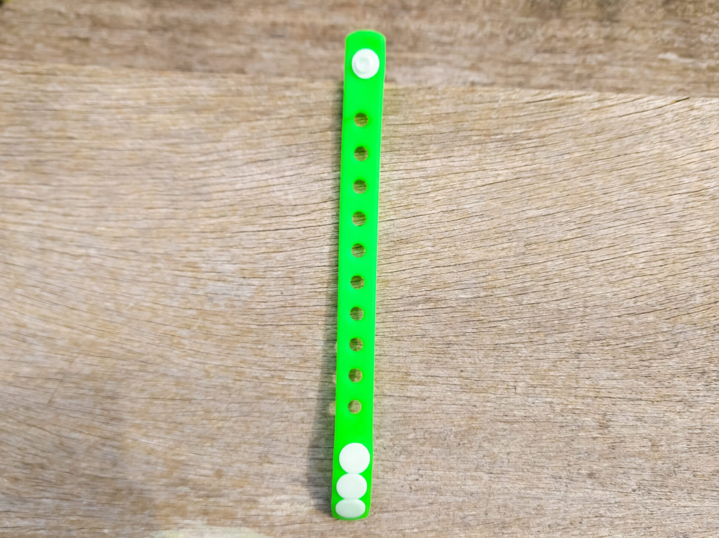 A flexible, adjustable bracelet with multiple charm slots, available in a range of vibrant colors for a personalized look.