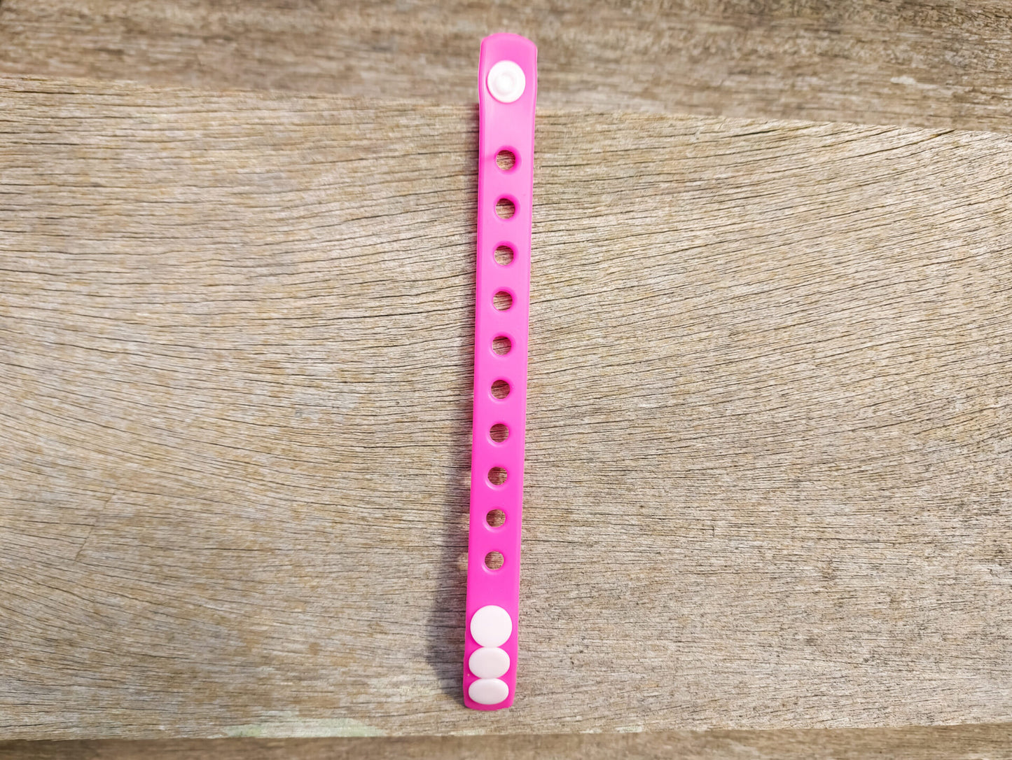 A flexible, adjustable bracelet with multiple charm slots, available in a range of vibrant colors for a personalized look.
