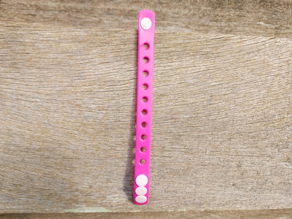 A flexible, adjustable bracelet with multiple charm slots, available in a range of vibrant colors for a personalized look.