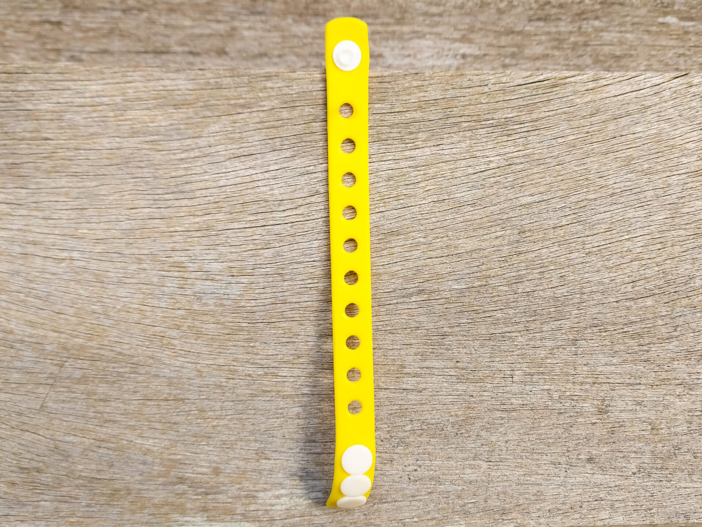 A flexible, adjustable bracelet with multiple charm slots, available in a range of vibrant colors for a personalized look.