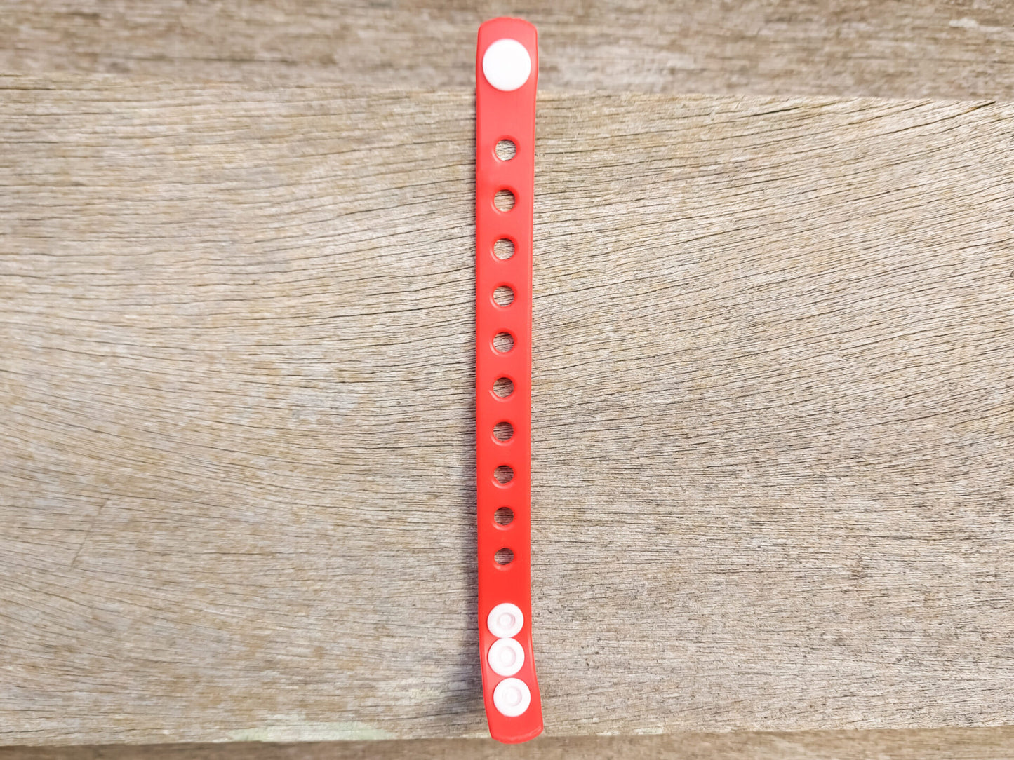 A flexible, adjustable bracelet with multiple charm slots, available in a range of vibrant colors for a personalized look.