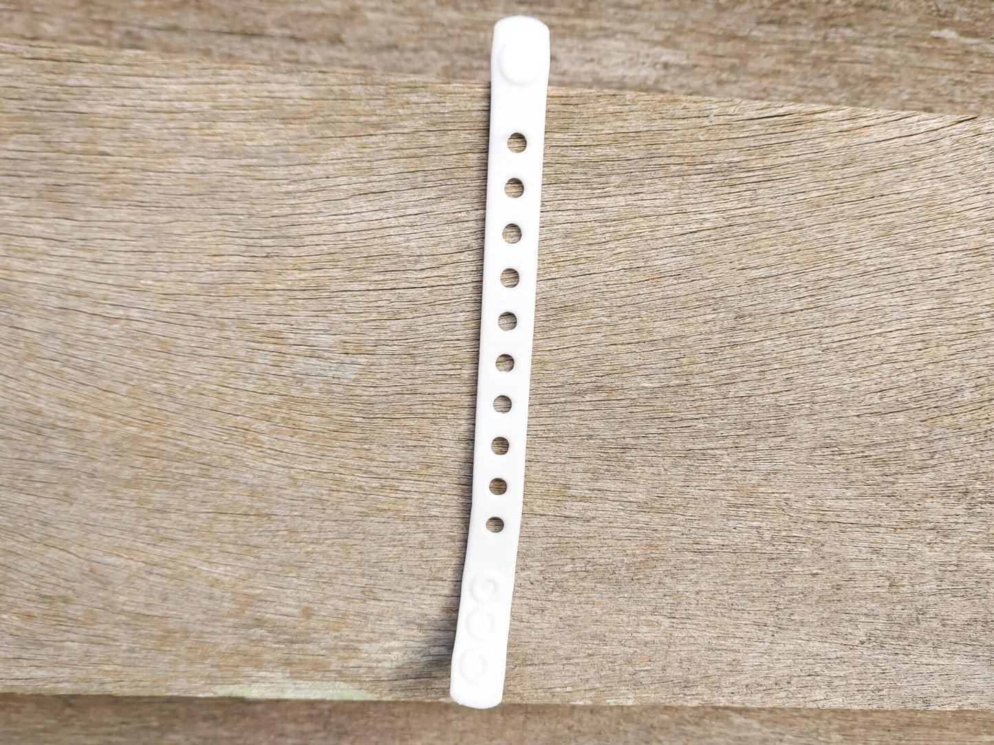 A flexible, adjustable bracelet with multiple charm slots, available in a range of vibrant colors for a personalized look.