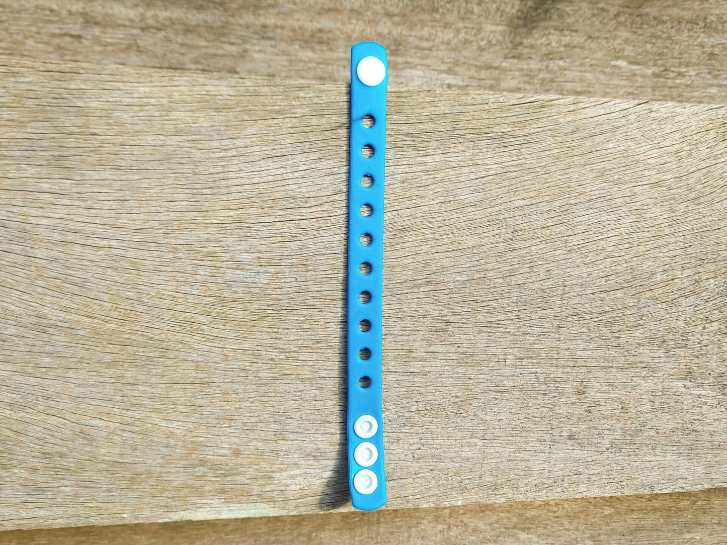 A flexible, adjustable bracelet with multiple charm slots, available in a range of vibrant colors for a personalized look.