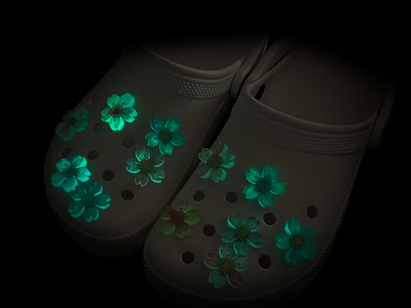 Glow-in-the-dark cherry blossom shoe charms in six colors—pink, dark pink, purple, blue, green, and orange—adding a soft, luminous effect to shoes with flower-themed elegance.