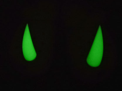 Pair of tan shoes with large glow-in-the-dark 3D printed rhino horn charms attached to the front, placed on a wooden surface.