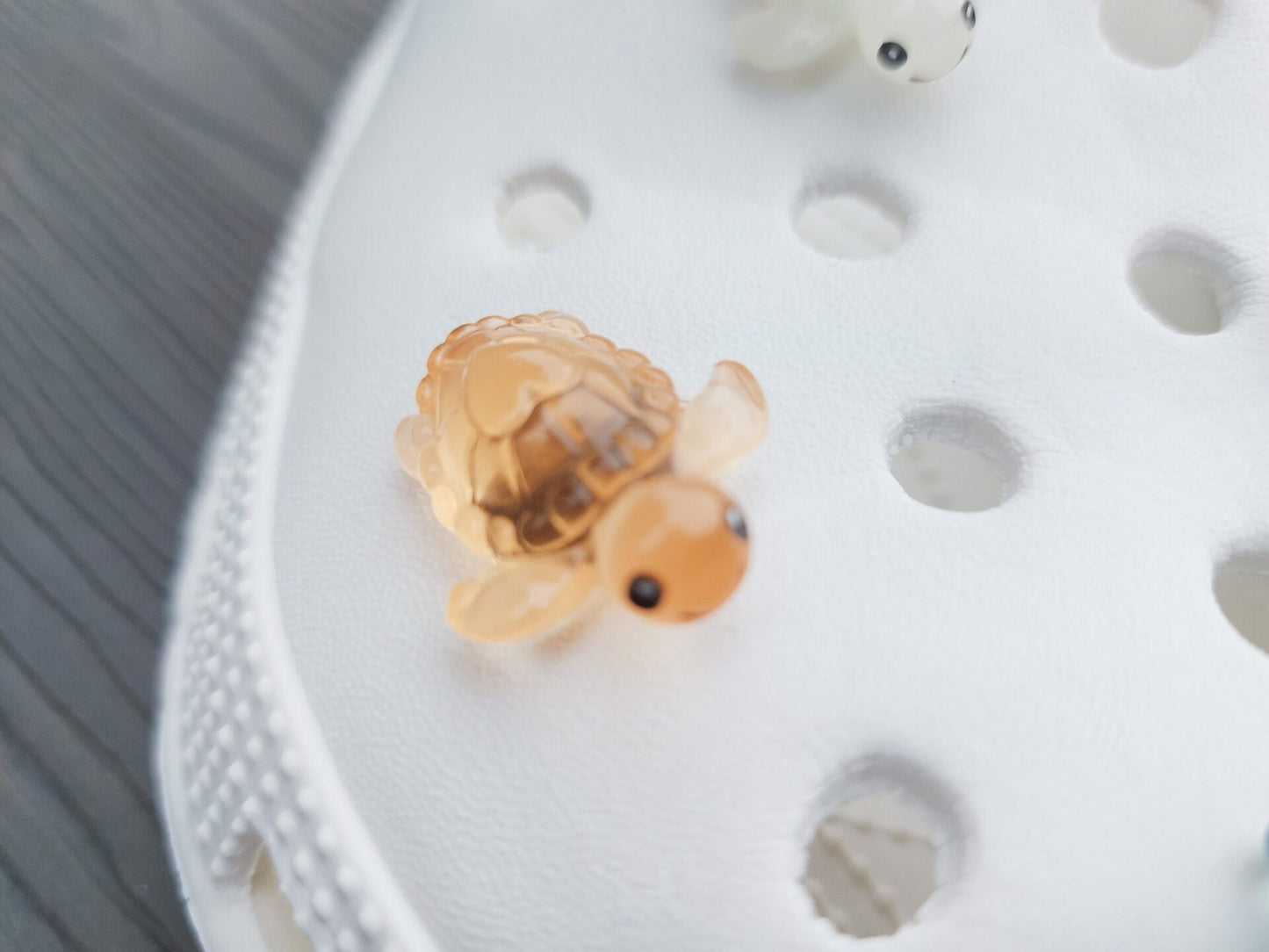 Glow-in-the-dark turtle charms for shoes, adding playful and whimsical style. These luminous accessories personalize your footwear with a fun touch, perfect for enhancing your shoes.