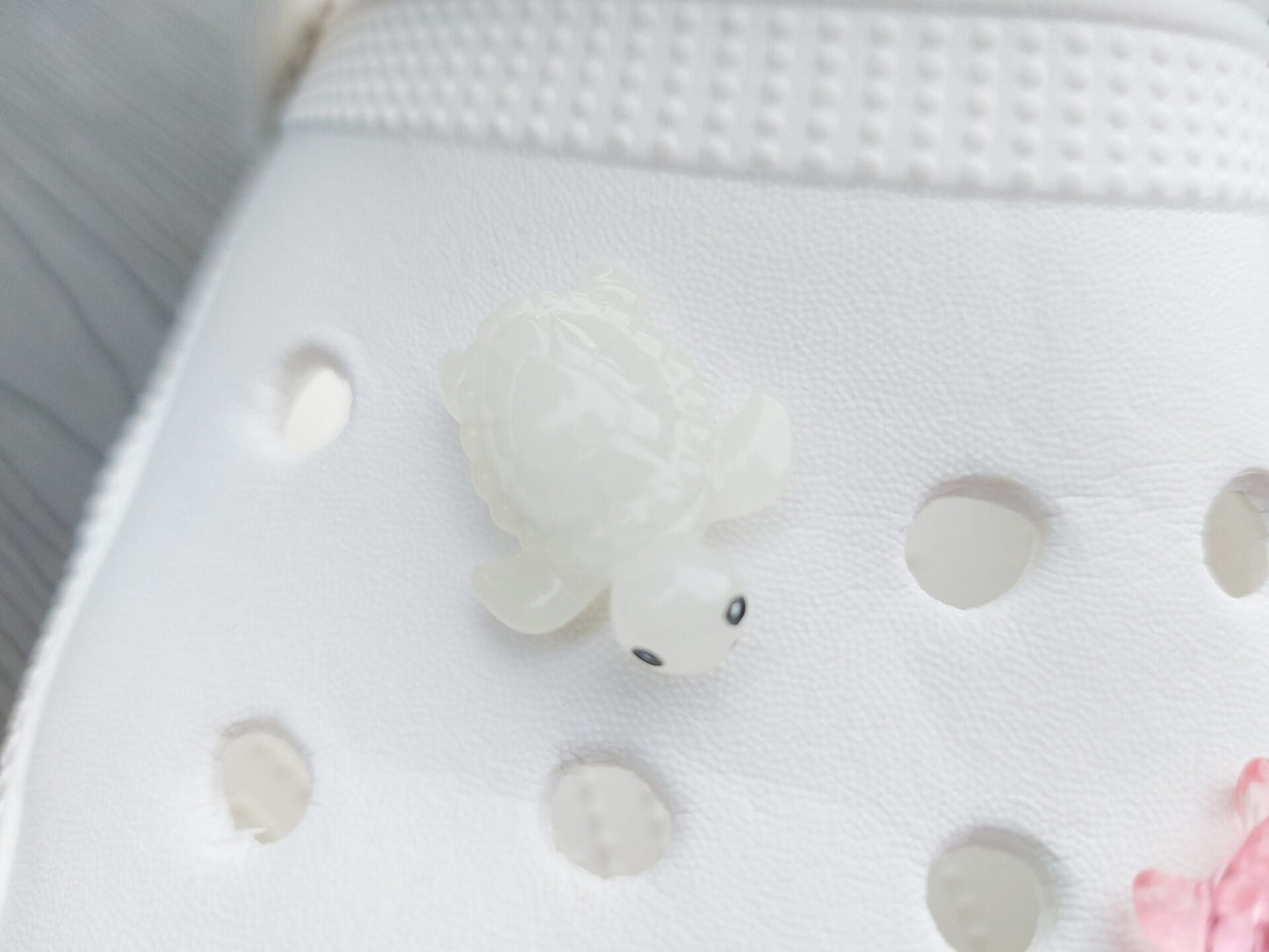 Glow-in-the-dark turtle charms for shoes, adding playful and whimsical style. These luminous accessories personalize your footwear with a fun touch, perfect for enhancing your shoes.
