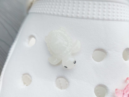 Glow-in-the-dark turtle charms for shoes, adding playful and whimsical style. These luminous accessories personalize your footwear with a fun touch, perfect for enhancing your shoes.