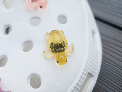 Glow-in-the-dark turtle charms for shoes, adding playful and whimsical style. These luminous accessories personalize your footwear with a fun touch, perfect for enhancing your shoes.