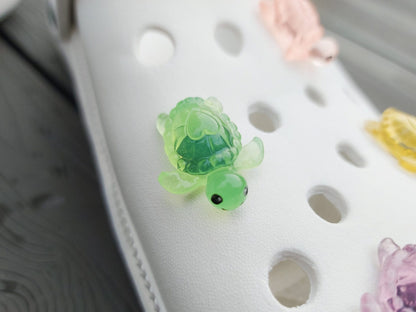 Glow-in-the-dark turtle charms for shoes, adding playful and whimsical style. These luminous accessories personalize your footwear with a fun touch, perfect for enhancing your shoes.