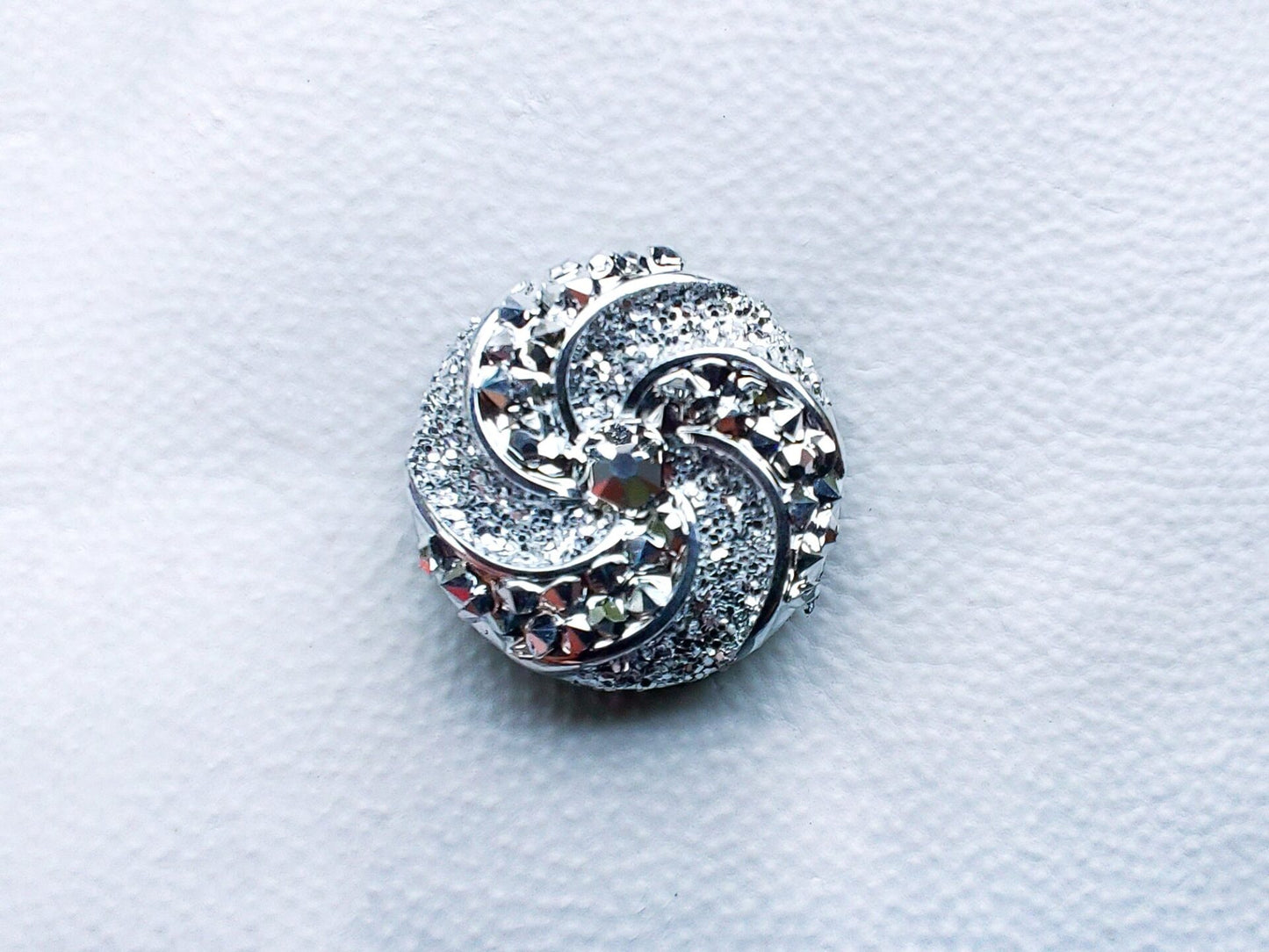 Colorful crystal round charms with sparkly rhinestones on a brown shoe shoe. These vibrant and glittering accessories add a dazzling touch to your footwear, perfect for customizing your shoes with a unique and eye-catching sparkle.