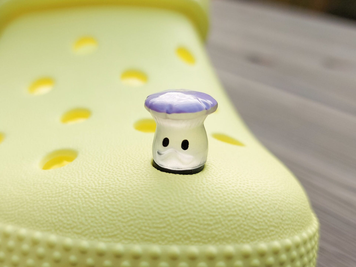 Glow-in-the-dark wild mushroom charms on a shoe shoe. These whimsical accessories light up in the dark, adding a magical and nature-inspired touch to your footwear. Perfect for customizing your shoes with a unique forest theme.