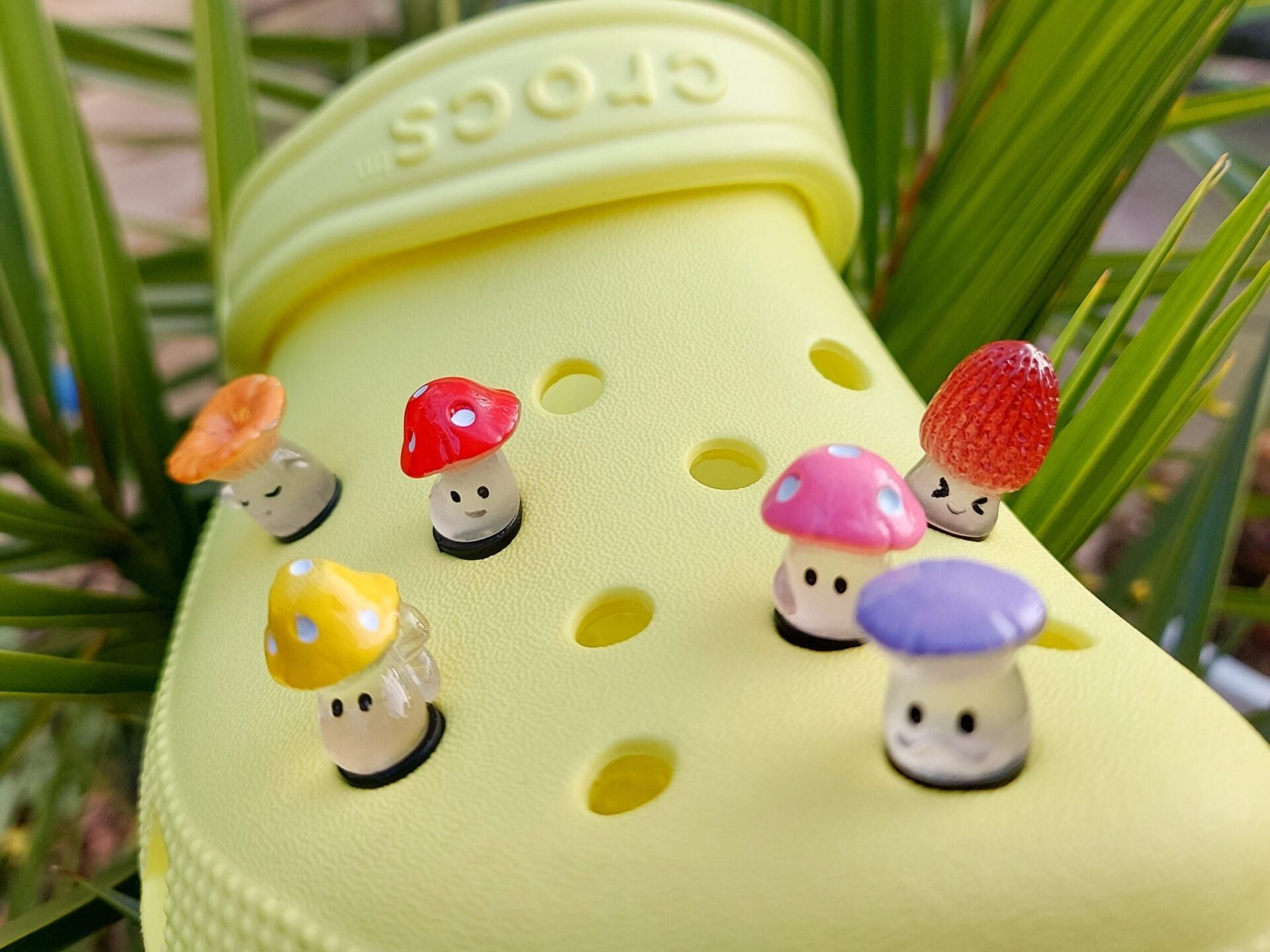 Glow-in-the-dark wild mushroom charms on a shoe shoe. These whimsical accessories light up in the dark, adding a magical and nature-inspired touch to your footwear. Perfect for customizing your shoes with a unique forest theme.