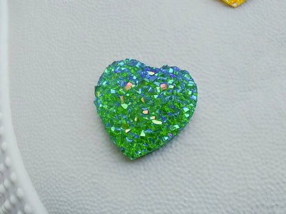 Sparkly and glittery rhinestone shoe charms in heart shapes on a pair of shoes shoes. Different colors such as silver, gold, rose, jade, amethyst, diamond.