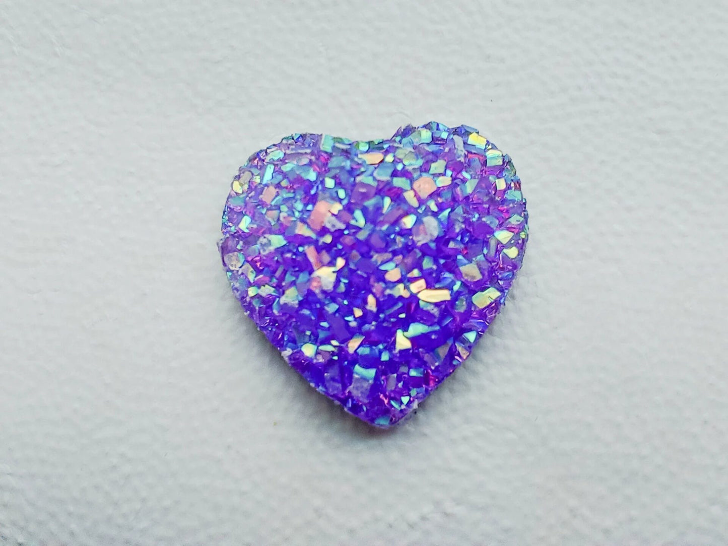 Sparkly and glittery rhinestone shoe charms in heart shapes on a pair of shoes shoes. Different colors such as silver, gold, rose, jade, amethyst, diamond.