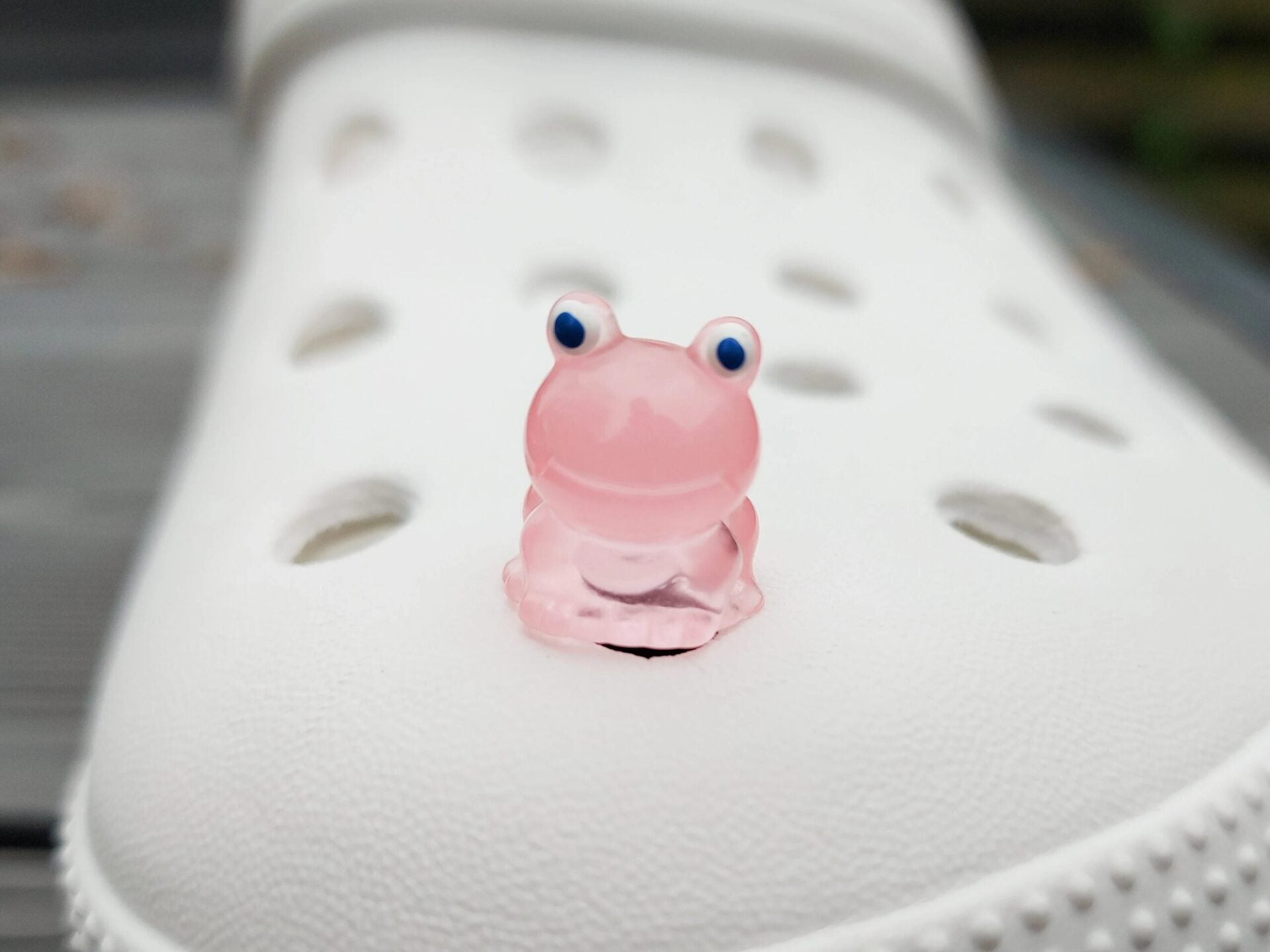 Glow-in-the-dark frog charms on a shoe shoe. These playful and luminous accessories add a fun, froggy touch to your footwear, making them perfect for customizing your shoes with a whimsical and adventurous vibe.