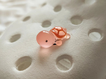 Glow-in-the-dark turtle charms on a shoe shoe. These adorable accessories, featuring detailed shell designs, bring a playful and luminous touch to the footwear, perfect for customizing your shoes with a fun, ocean-inspired look.