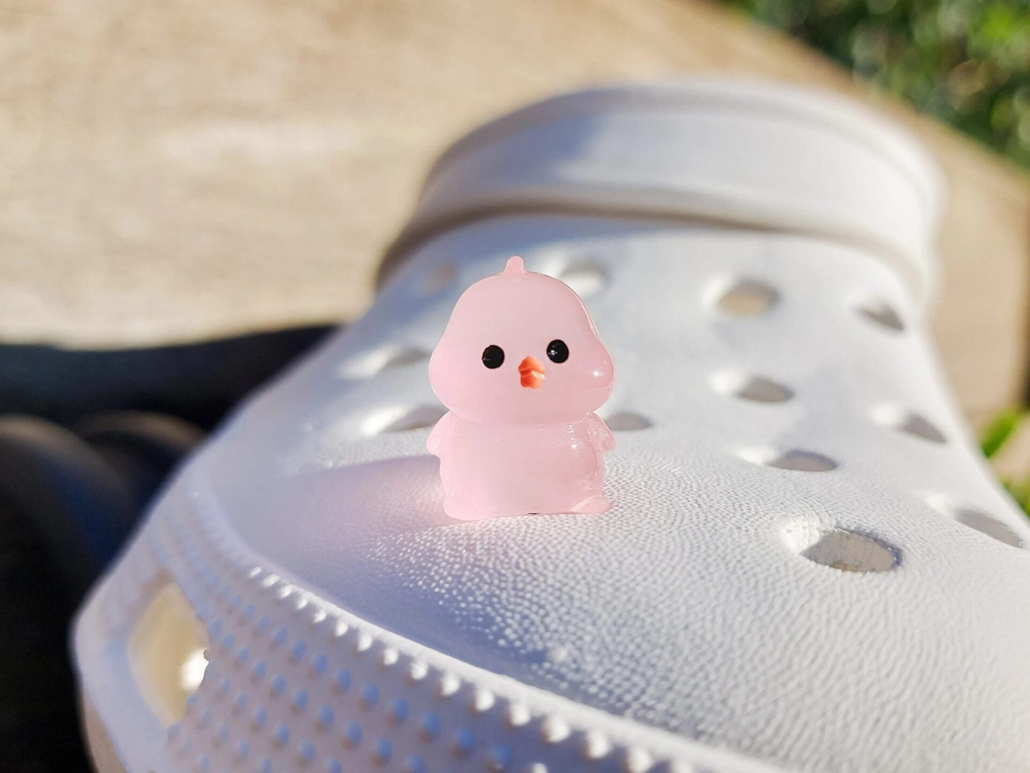 Glow-in-the-dark chicken shoe charms showcasing plump, colorful chickens with playful details like tiny wings and combs. Each charm glows in various neon shades, adding a fun and quirky touch to your shoes, perfect for farm animal lovers.