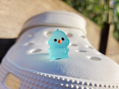 Glow-in-the-dark chicken shoe charms showcasing plump, colorful chickens with playful details like tiny wings and combs. Each charm glows in various neon shades, adding a fun and quirky touch to your shoes, perfect for farm animal lovers.