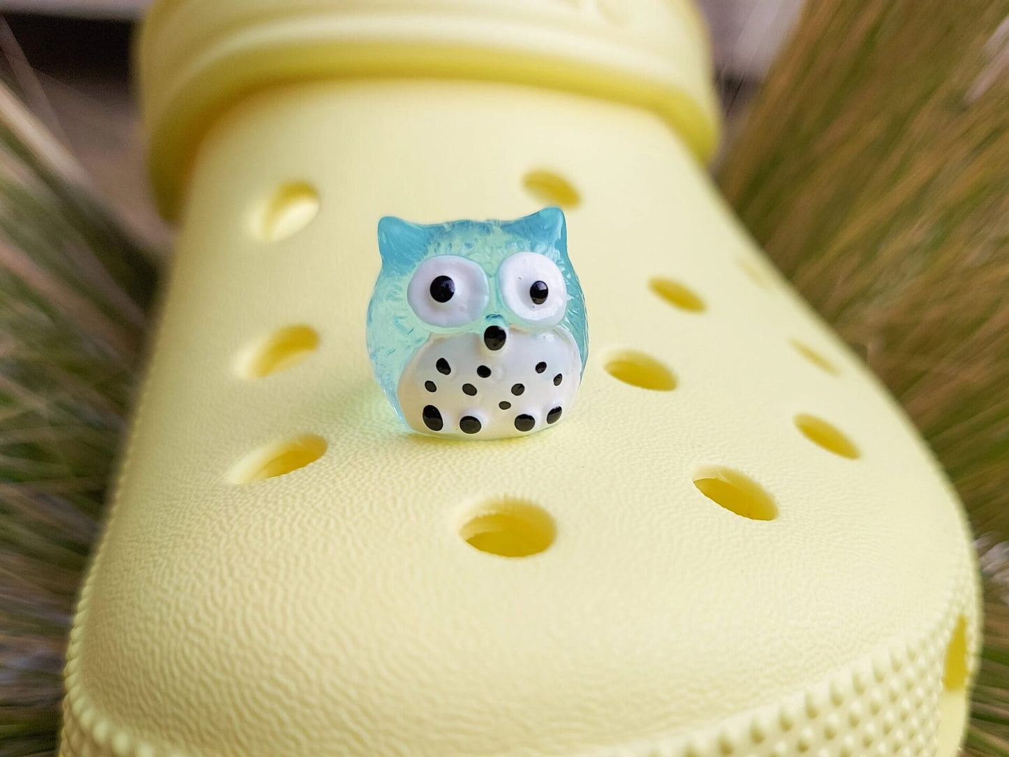 Glow-in-the-dark owl shoe charms featuring small, colorful owls with wide eyes and feathered details. These cute owls glow brightly in the dark, adding a magical and whimsical look to your shoes, perfect for those who love nocturnal creatures.