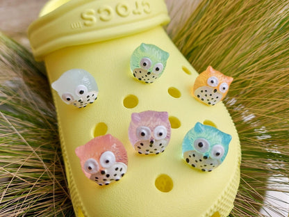 Glow-in-the-dark owl shoe charms featuring small, colorful owls with wide eyes and feathered details. These cute owls glow brightly in the dark, adding a magical and whimsical look to your shoes, perfect for those who love nocturnal creatures.