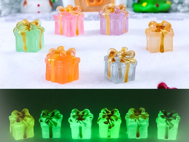 Glow in the dark christmas present charms on a yellow shoes shoe. It is a gift box with a big ribbon on top available in blue, pink, green, orange and peach. Xmas-themed perfect for the holidays.