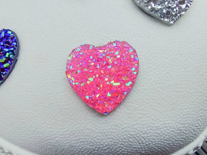 Sparkly and glittery rhinestone shoe charms in heart shapes on a pair of shoes shoes. Different colors such as silver, gold, rose, jade, amethyst, diamond.