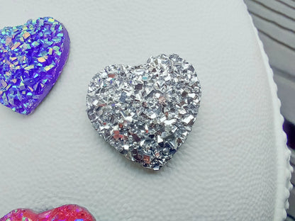 Sparkly and glittery rhinestone shoe charms in heart shapes on a pair of shoes shoes. Different colors such as silver, gold, rose, jade, amethyst, diamond.