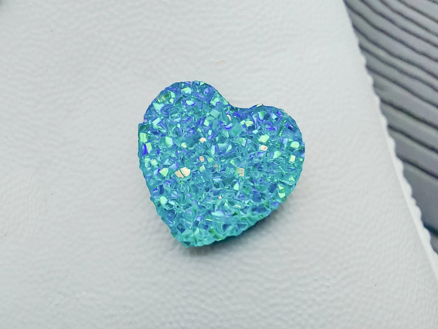 Sparkly and glittery rhinestone shoe charms in heart shapes on a pair of shoes shoes. Different colors such as silver, gold, rose, jade, amethyst, diamond.
