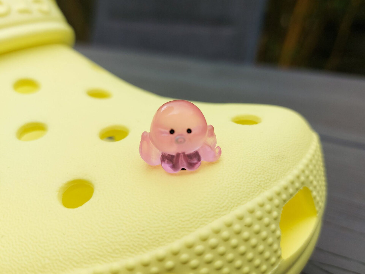 Glow in the dark octopus shoe charms on a pair of shoes shoes. Luminous charms in different colors.