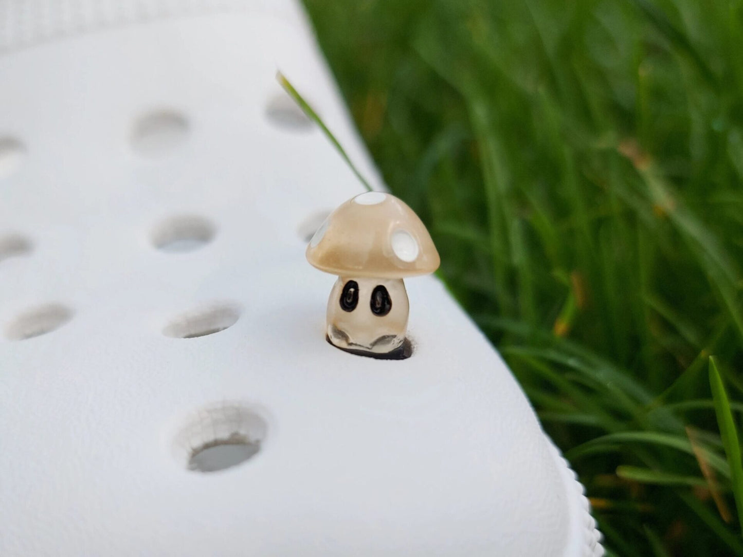 Glow-in-the-dark mushroom charms on a pair of shoes shoes. These luminous accessories add a magical, whimsical touch to your footwear, perfect for customizing with a unique forest-inspired design that glows beautifully in the dark.