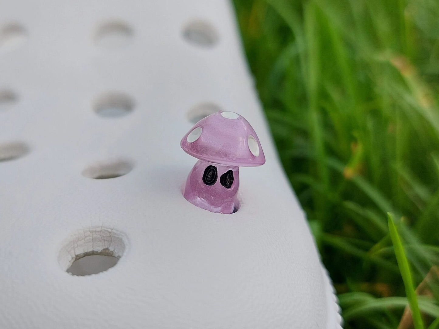 Glow-in-the-dark mushroom charms on a pair of shoes shoes. These luminous accessories add a magical, whimsical touch to your footwear, perfect for customizing with a unique forest-inspired design that glows beautifully in the dark.